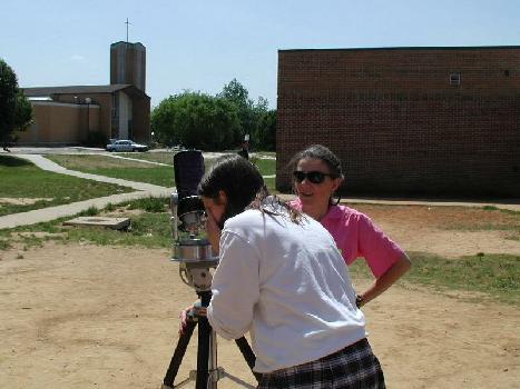 two women looking through telescope