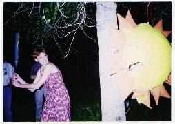 woman hitting sun pinata