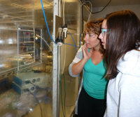 two young women looking at lab